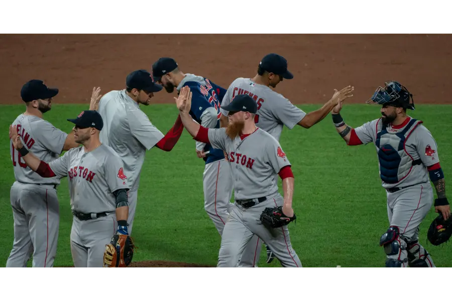 Boston Red Sox players including Mitch Moreland, Craig Kimbrel, William Cuevas and Sandy Leon congratulate each other after a win at Camden Yards in Baltimore in 2018